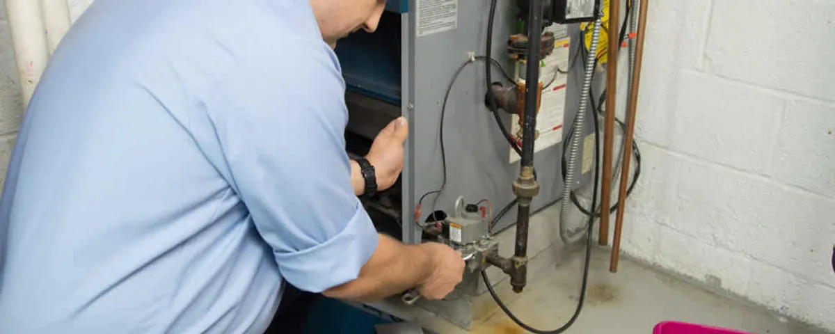 Furnace repair technician inspecting and servicing a home heating system in Oak Park, IL