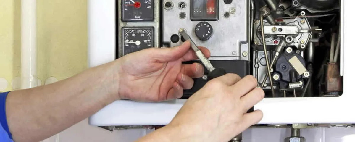 Heating repair technician adjusting boiler controls and components in Oak Park, IL