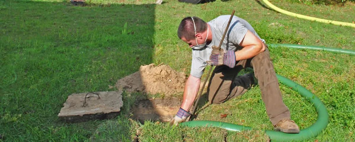 Septic pumping technician servicing a residential septic tank in Oak Park, IL